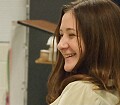 Danielle failing miserably at smug director look.